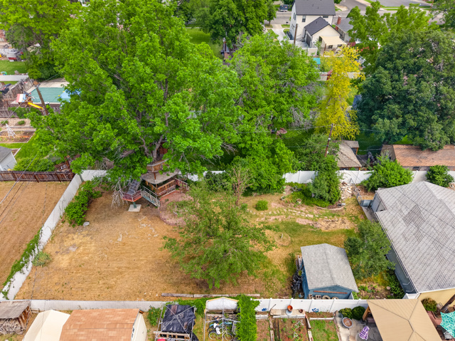 74 South 300 East Springville, UT 84663 - Photo 47 of 48 Expansive backyard featuring mature trees, a multi-level treehouse with steps, partial fencing, and varied landscaping