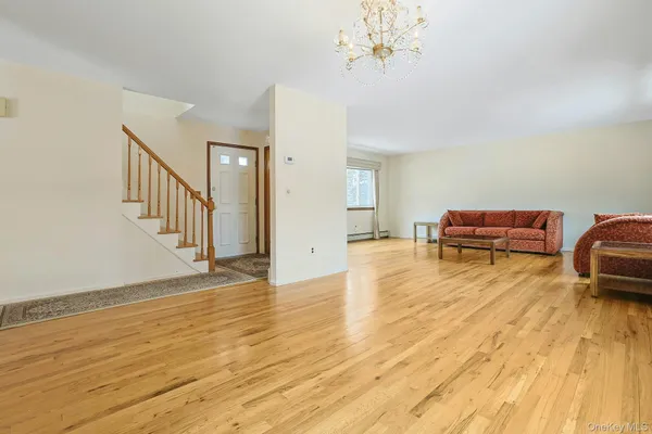 a view of livingroom with dining room and wooden floor