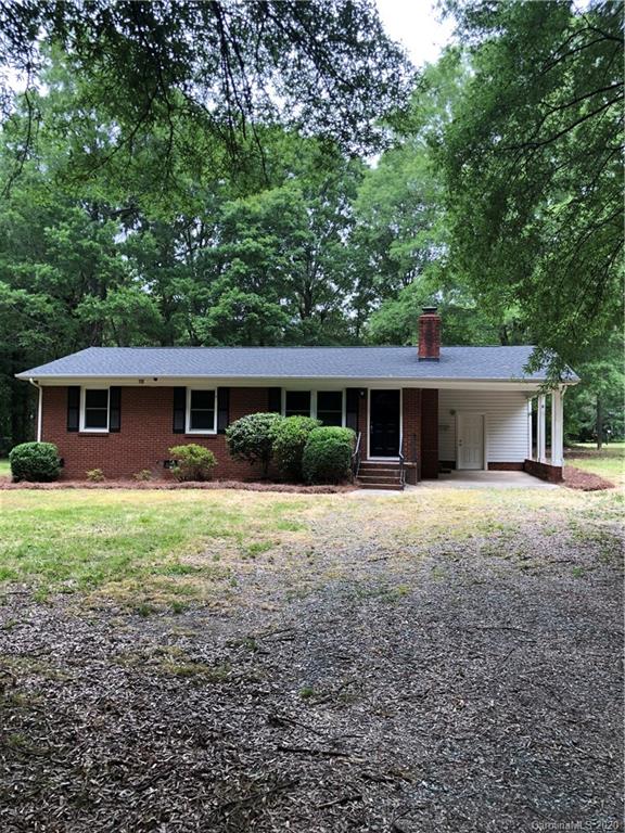 a front view of a house with a yard and a garage