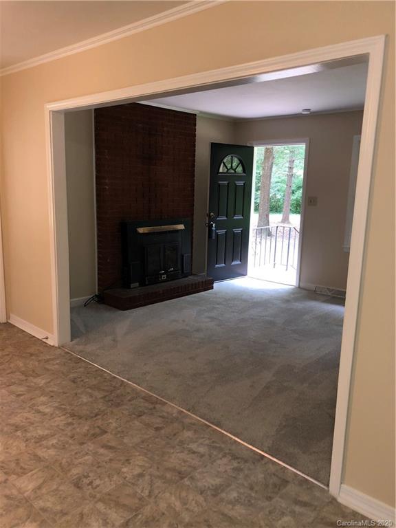 2117 White Store Road, Unit 126 Monroe, NC 28112 - Photo 11 of 20 a view of an empty room with a fireplace and a large window