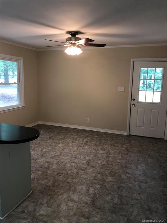 2117 White Store Road, Unit 126 Monroe, NC 28112 - Photo 10 of 20 en empty room with windows and chandelier fan
