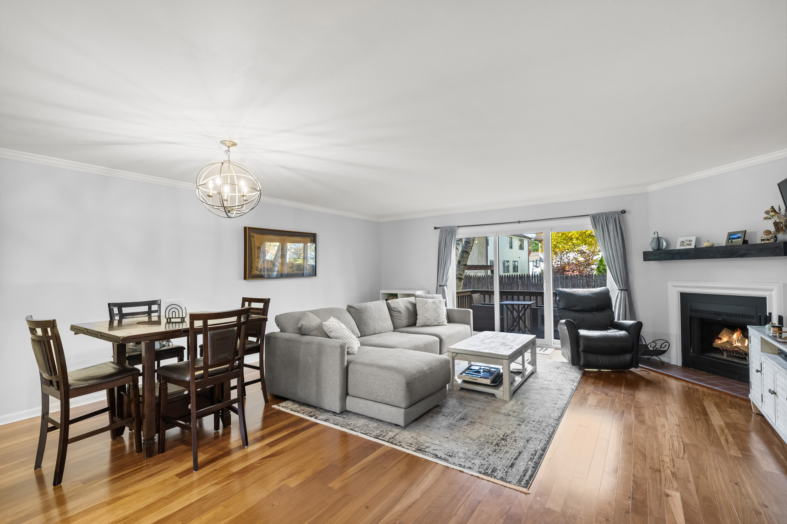 48 Randall Avenue, Unit 3 Stamford, CT 06905 - Photo 6 of 25 a living room with furniture a fireplace and a dining table with wooden floor