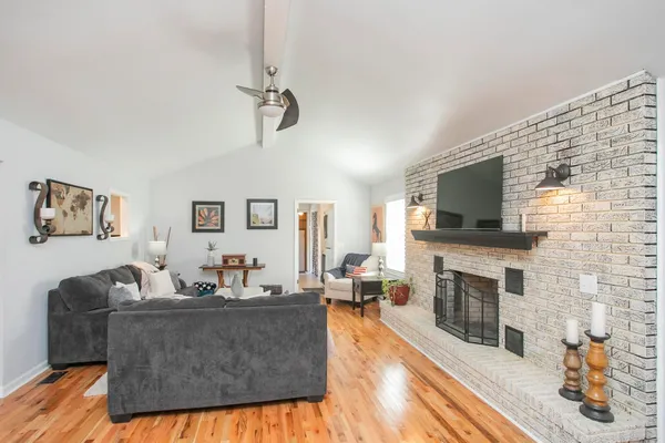 a living room with fireplace furniture and a flat screen tv
