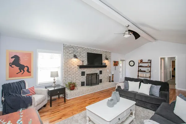 a living room with furniture and a flat screen tv