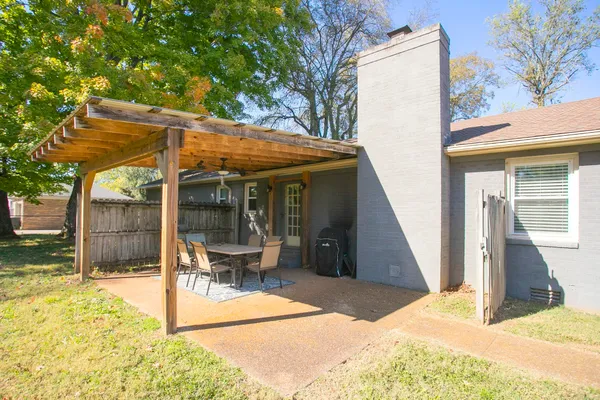 a view of a house with backyard porch and sitting area