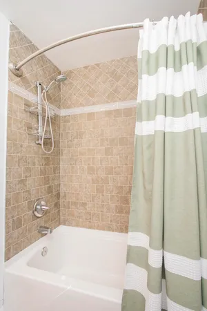 a bathroom with a bathtub and shower
