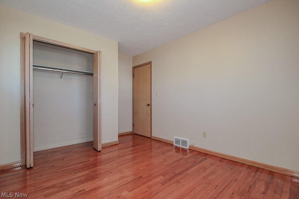30224 Regent Road Wickliffe, OH 44092 - Photo 17 of 27 Unfurnished bedroom with light wood-style floors and a closet