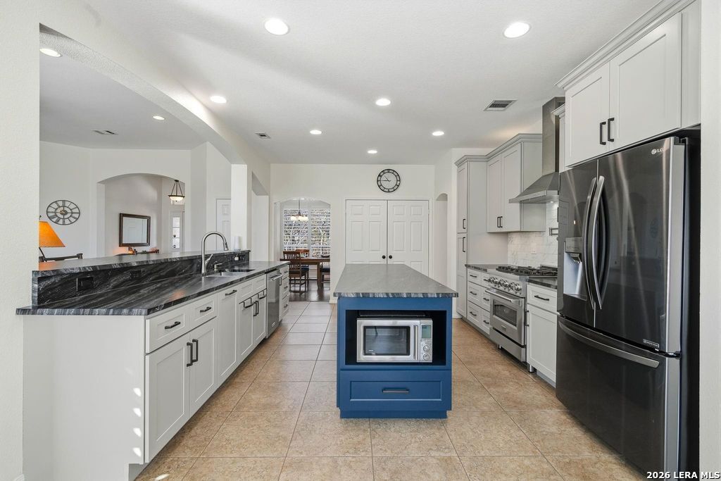 318 River Ridge Boerne, TX 78006 - Photo 13 of 46 a large kitchen with stainless steel appliances kitchen island granite countertop a refrigerator and a stove