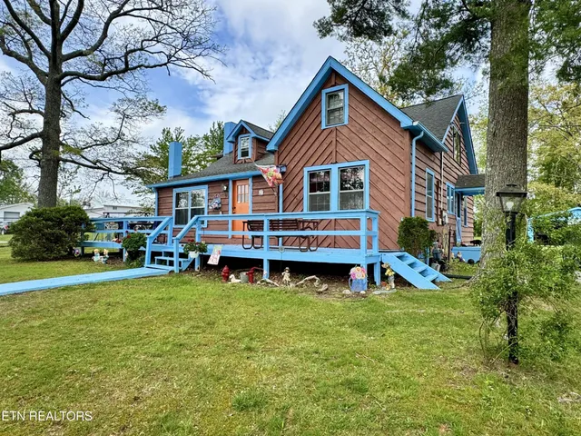 a view of a house with swimming pool and sitting area
