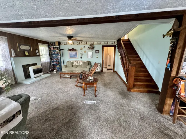 a living room with furniture a window and gym equipment