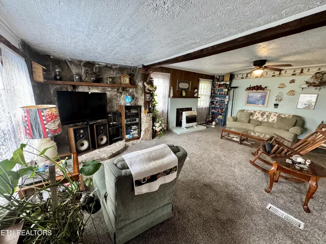 a view of a hallway with furniture and a window