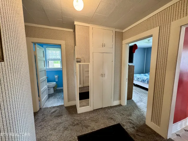 a bedroom with a bed and a television