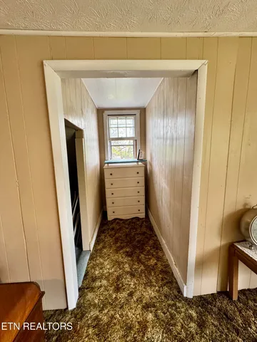 a view of backyard of house and garage