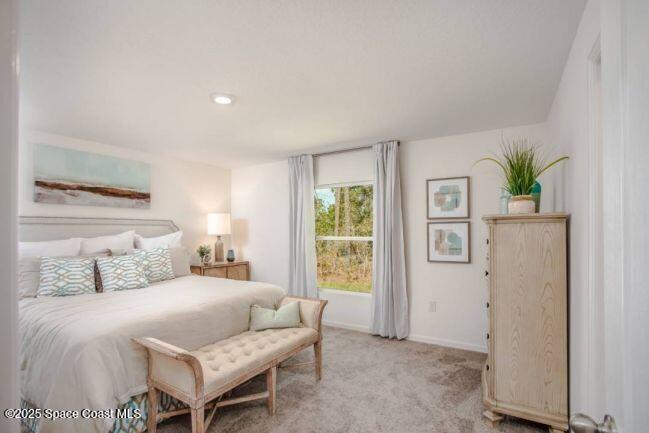 671 Weaver Road Southwest Palm Bay, FL 32908 - Photo 9 of 22 a bedroom with a bed and a table