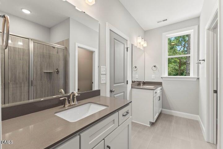 25 West Victoria Rdg Drive, Unit 15 Selma, NC 27576 - Photo 31 of 35 a bathroom with a granite countertop sink mirror and double