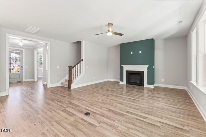 25 West Victoria Rdg Drive, Unit 15 Selma, NC 27576 - Photo 5 of 35 a view of an empty room with wooden floor fireplace and a window