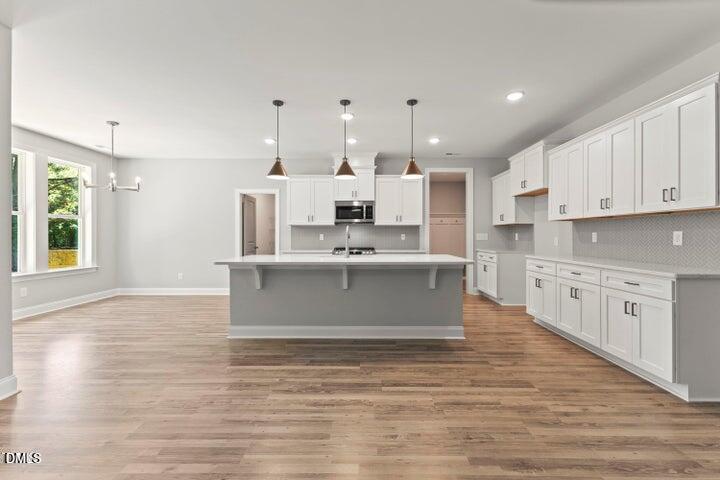 25 West Victoria Rdg Drive, Unit 15 Selma, NC 27576 - Photo 7 of 35 a large kitchen with kitchen island a sink stainless steel appliances and cabinets