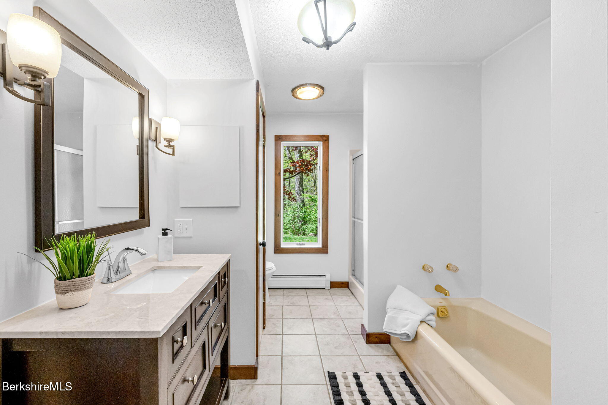 1874 Home Road Sheffield, MA 01230 - Photo 35 of 42 a bathroom with a tub sink and mirror