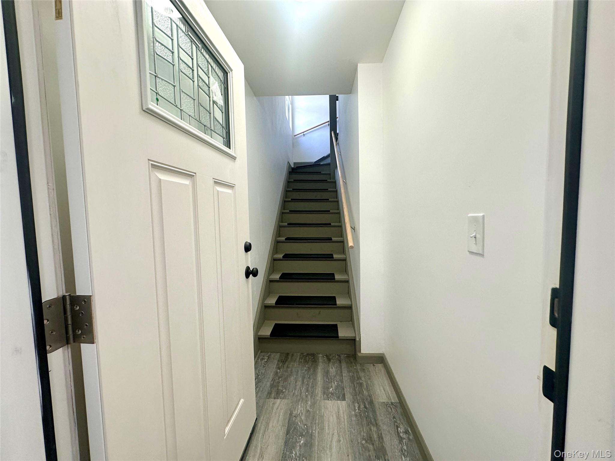 2187 Highway 302, Unit 2 Middletown, NY 10941 - Photo 3 of 13 a view of a hallway with wooden floor and stairs