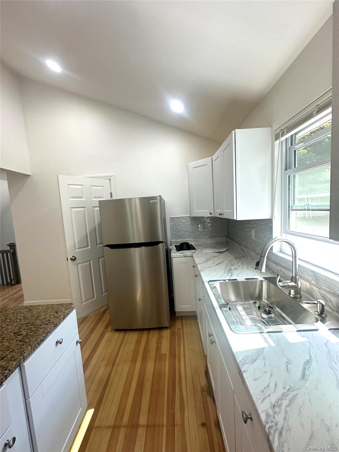 2187 Highway 302, Unit 2 Middletown, NY 10941 - Photo 4 of 13 a kitchen with kitchen island granite countertop a sink stove and refrigerator