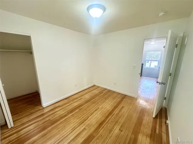 a view of a room with wooden floor and bathroom