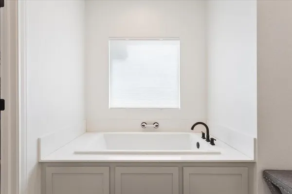 a bathroom with a sink and a window