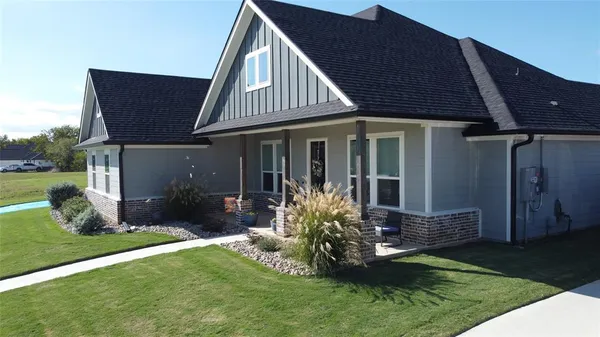 a front view of a house with garden