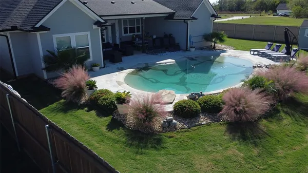 a view of a backyard with plants and patio