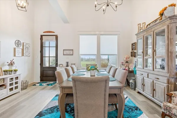 a dining room with furniture a flat screen tv and a large window