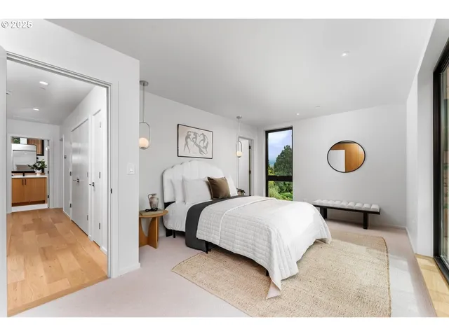 a bedroom with a large bed and a large window