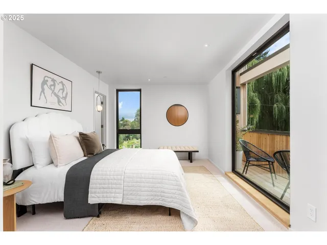 a bedroom with a bed and a painting on the wall