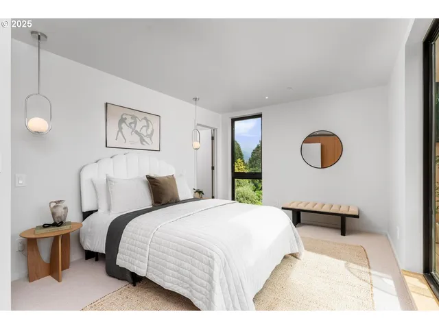 a bed room with a bed and a large window