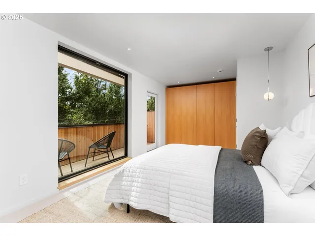 a bedroom with a bed and a painting