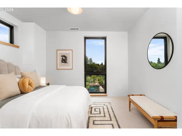 a bedroom with a bed and a painting on the wall