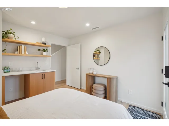 a bedroom with a bed and a painting on the wall