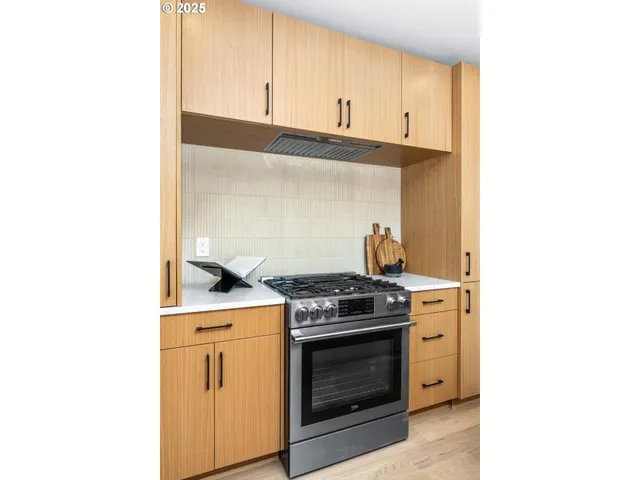 a kitchen with a stove and cabinets