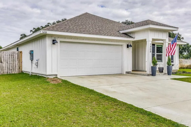 a view of a house with a big yard and large trees