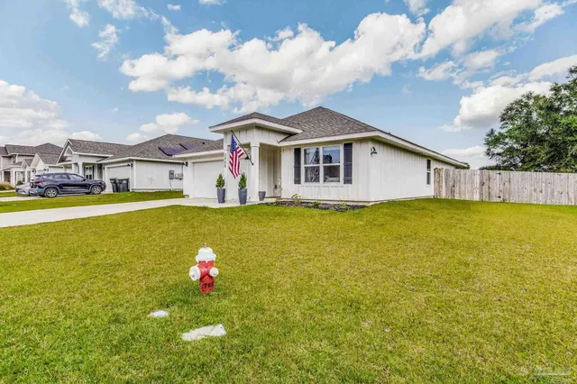 a bedroom with a bed a rug and wooden floor