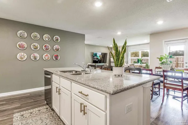 a living room with furniture kitchen and a table