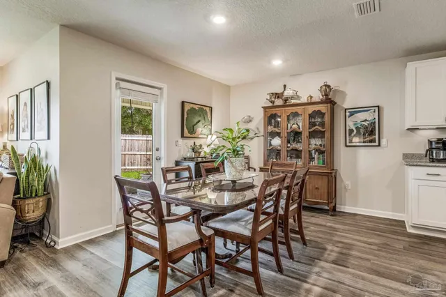 a view of a hallway view with wooden floor and a living room