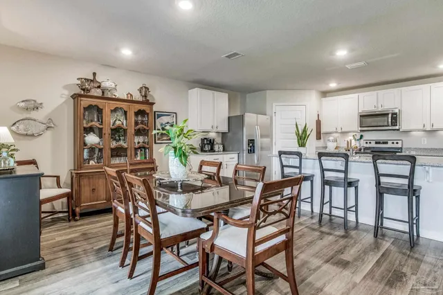 a kitchen with white cabinets and counter space