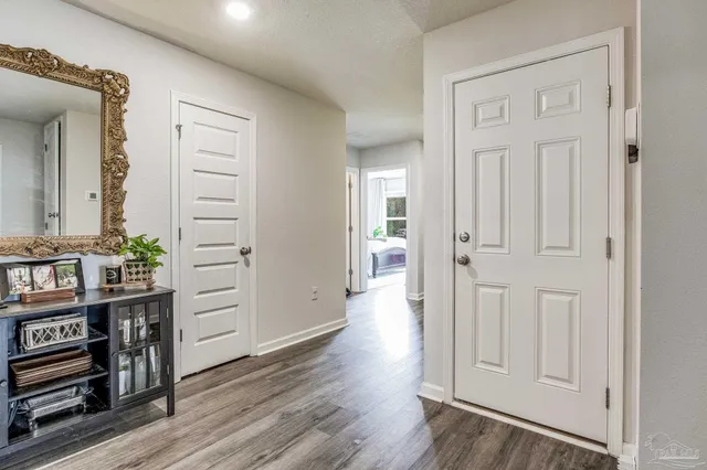 a spacious bathroom with a granite countertop sink and a mirror