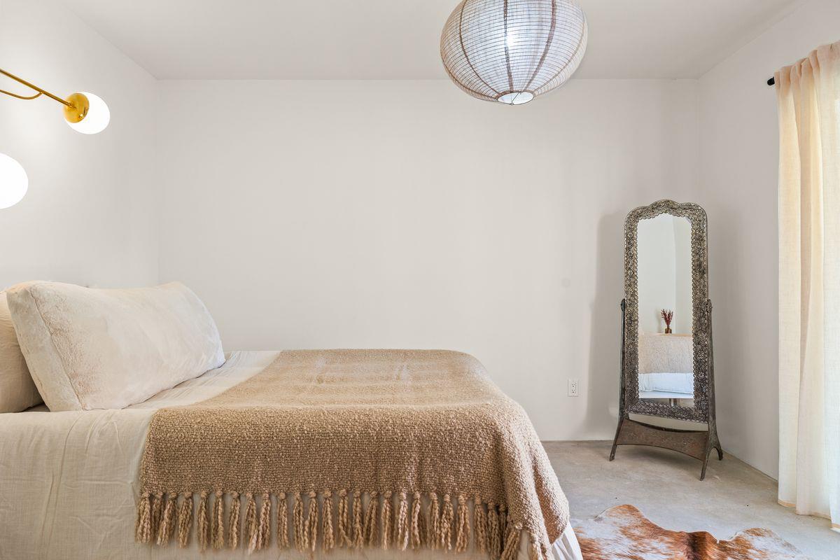 1107 South Rice Road Ojai, CA 93023 - Photo 11 of 24 a bedroom with a bed and a chandelier
