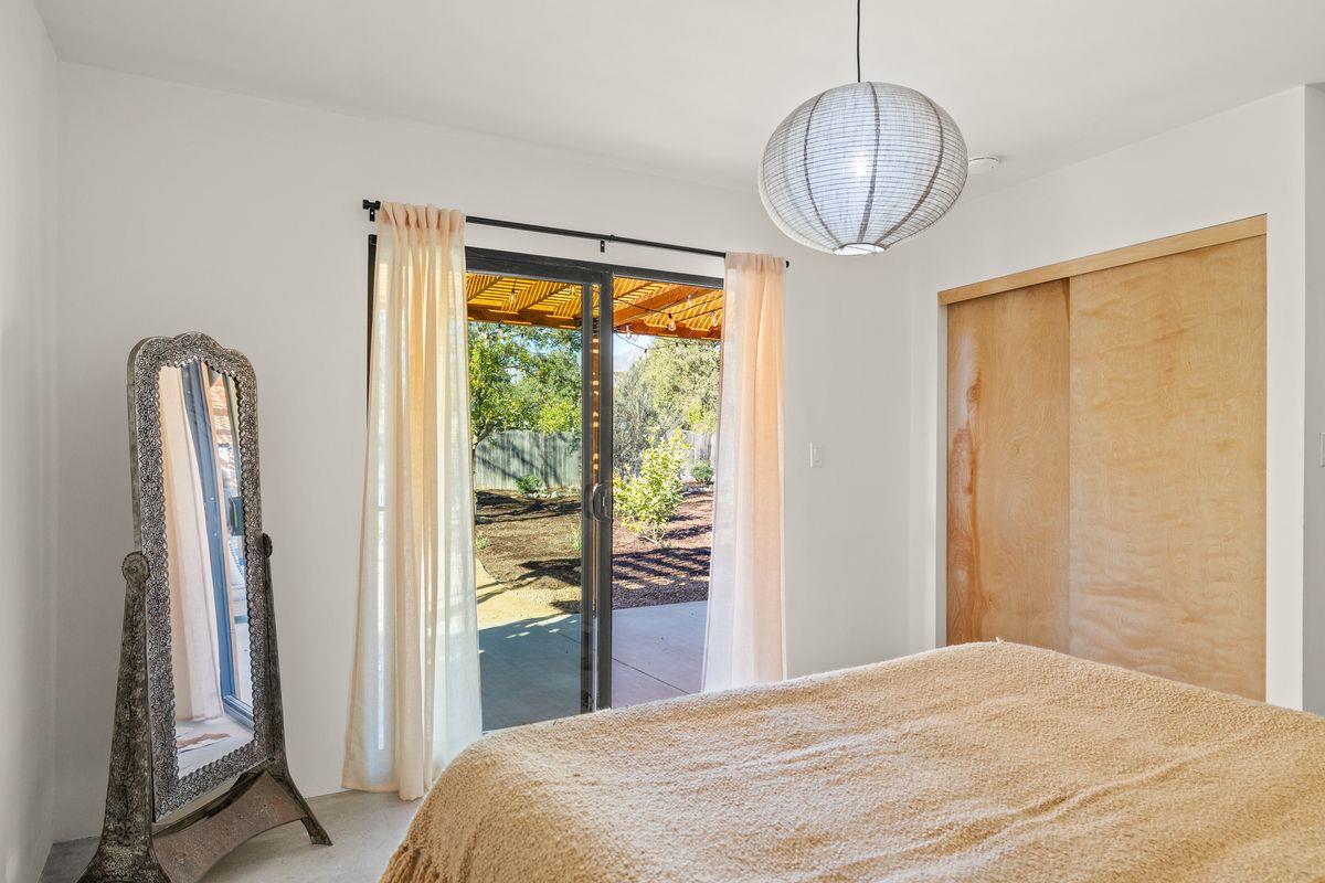 1107 South Rice Road Ojai, CA 93023 - Photo 12 of 24 a bedroom with a bed and a chandelier