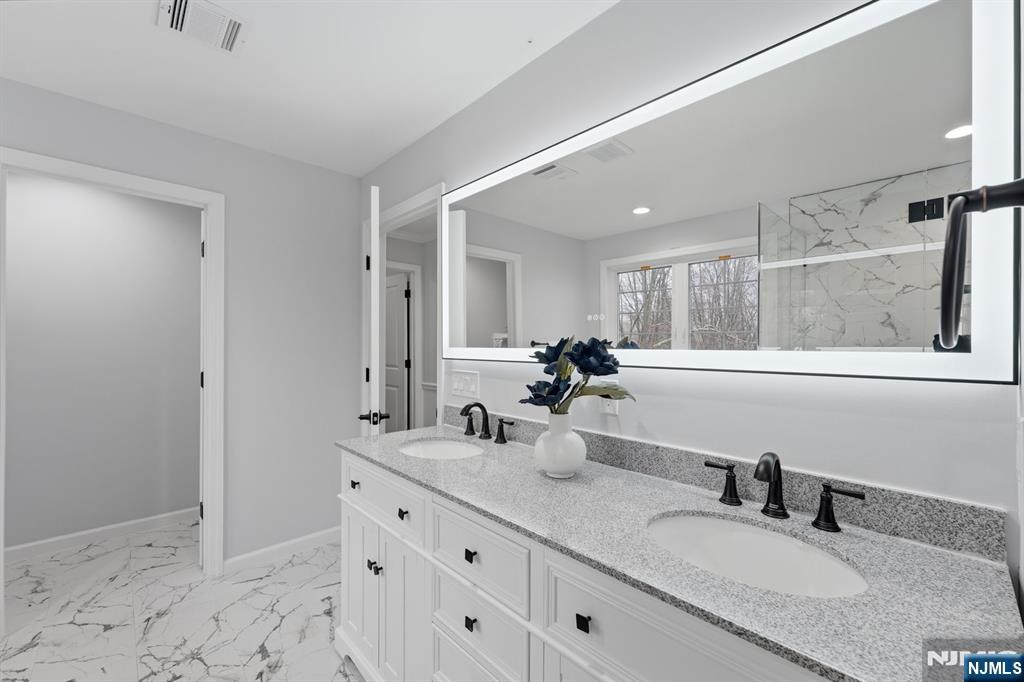 188 Edwards Road Parsippany, NJ 07054 - Photo 27 of 41 a bathroom with double vanity sink and a mirror