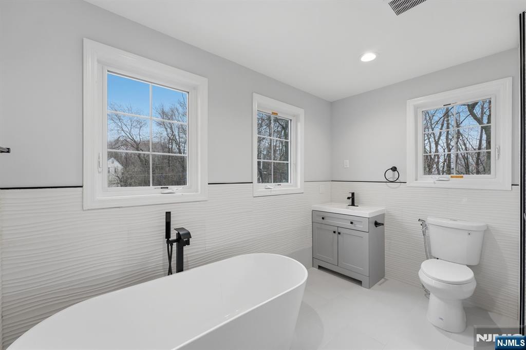 188 Edwards Road Parsippany, NJ 07054 - Photo 32 of 41 a bathroom with a toilet sink and mirror