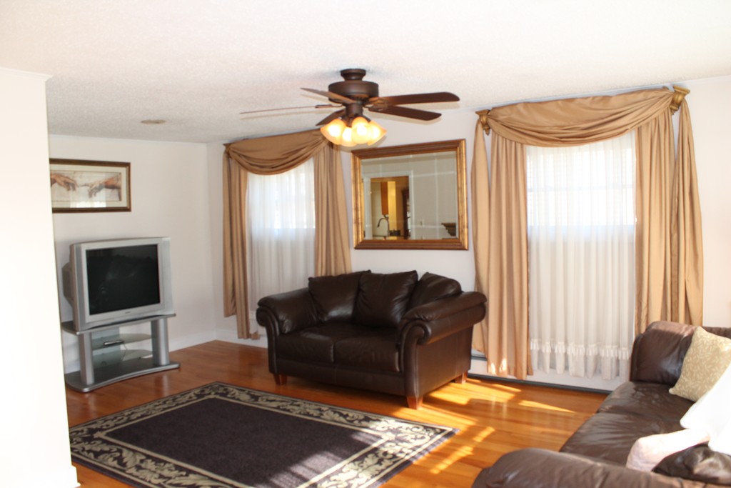 76 Brittany Road Springfield, MA 01151 - Photo 11 of 30 a living room with furniture and a flat screen tv