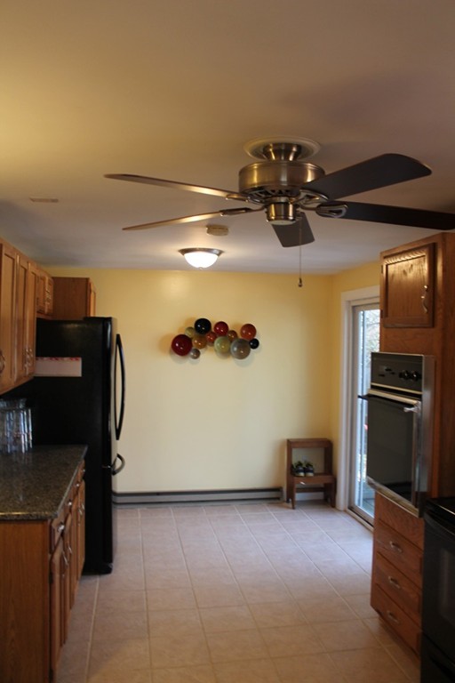 76 Brittany Road Springfield, MA 01151 - Photo 3 of 30 a view of kitchen with refrigerator cabinets and furniture