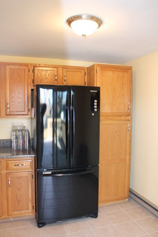 76 Brittany Road Springfield, MA 01151 - Photo 4 of 30 a view of a refrigerator in kitchen and a window