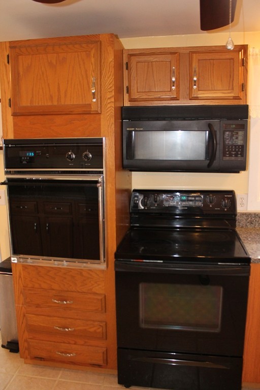 76 Brittany Road Springfield, MA 01151 - Photo 8 of 30 a stove top oven sitting inside of a kitchen